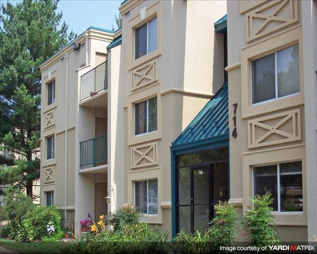 a group of apartment buildings with large windows