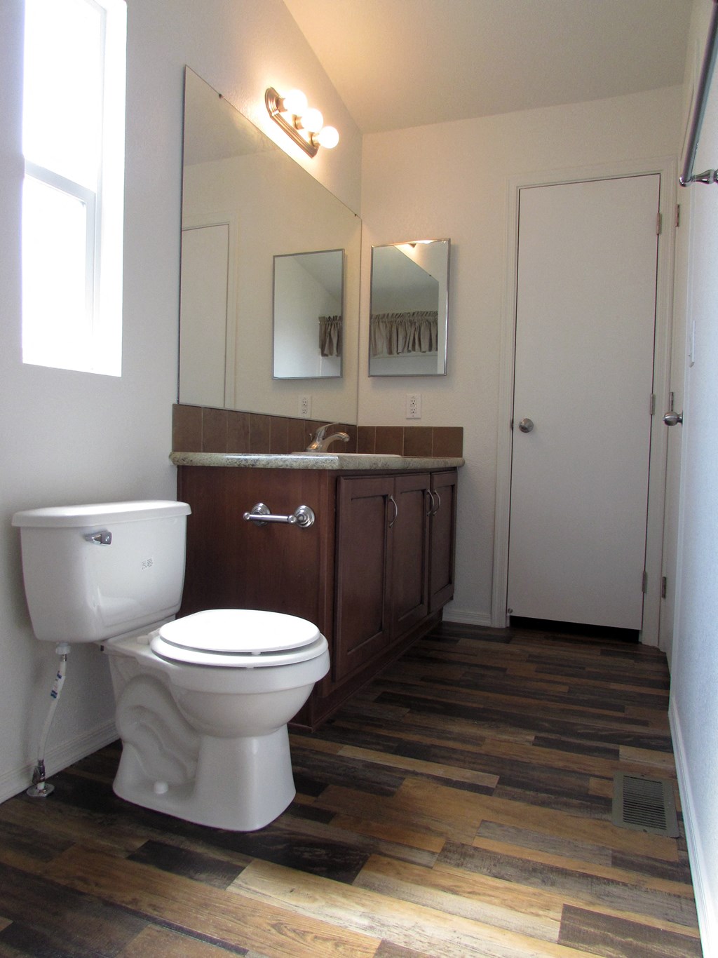 a bathroom with a toilet sink and mirror