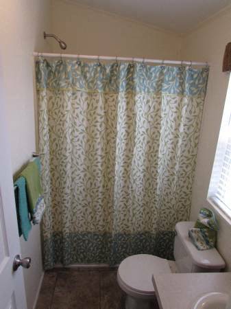 a bathroom with a shower curtain and a toilet