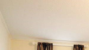 a living room with a white door and a window