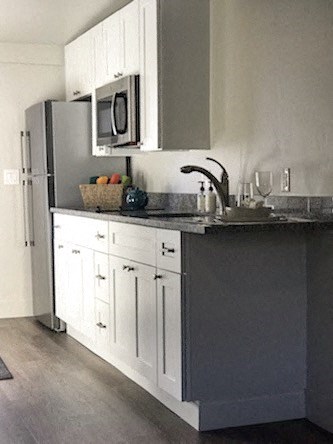 a kitchen with a sink and a refrigerator