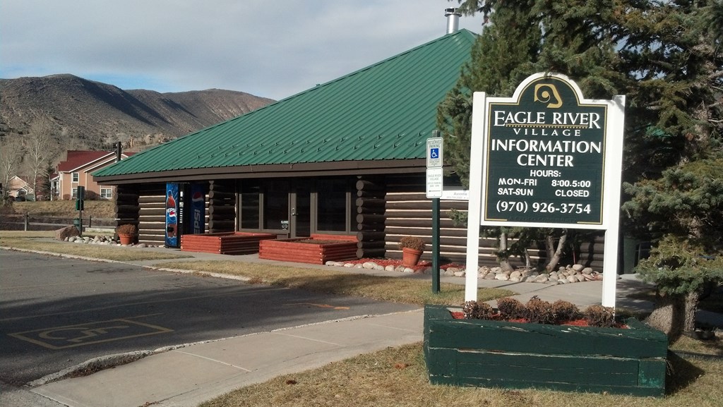 a building with a green roof and a sign that says eagle river intelligence information center