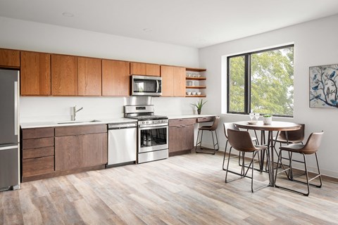 a kitchen with wooden cabinets and a table with chairs