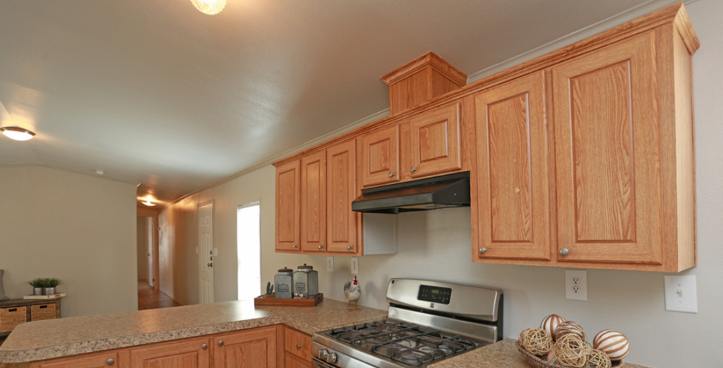 a kitchen with wooden cabinets and a stove top oven