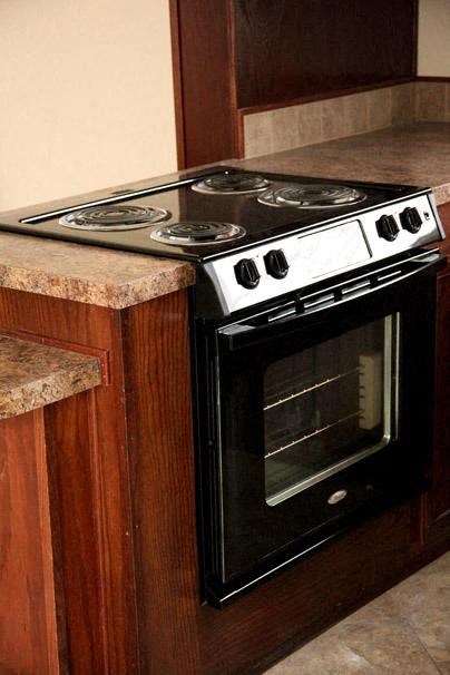 a stove top oven sitting inside of a kitchen