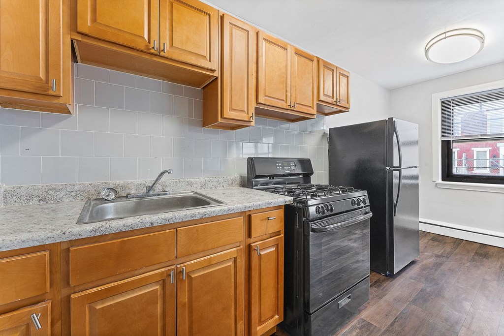 a kitchen with a sink and a refrigerator