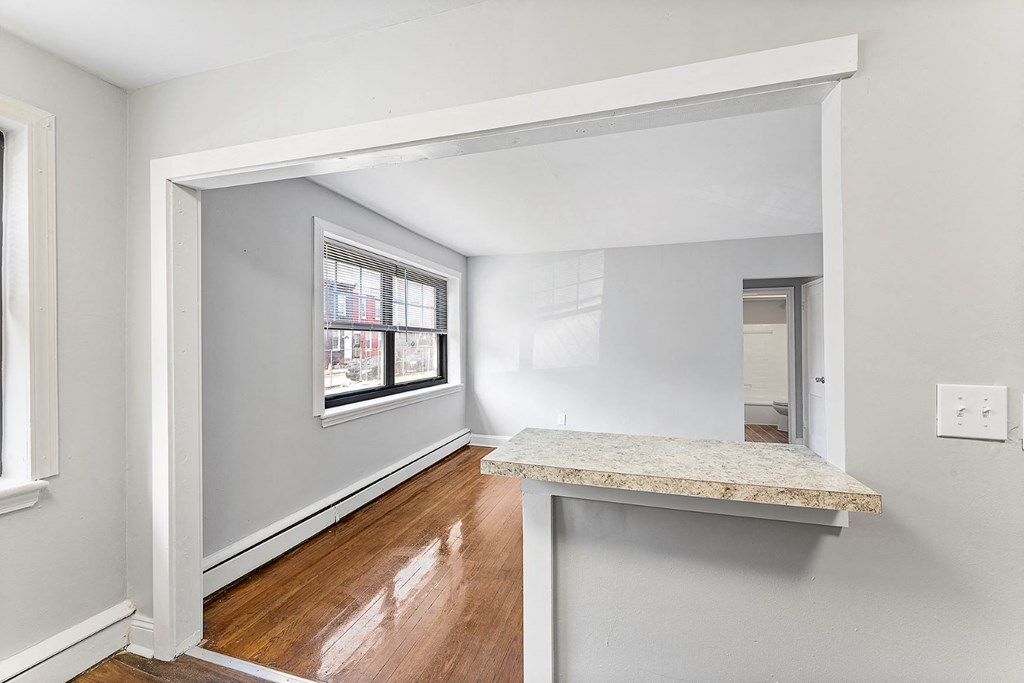 an empty room with a counter and a window