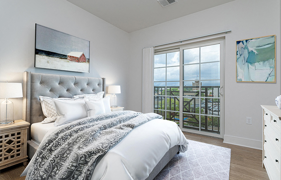 Gorgeous bedroom in luxury Ardmore, PA apartment with glass doors leading out to private patio