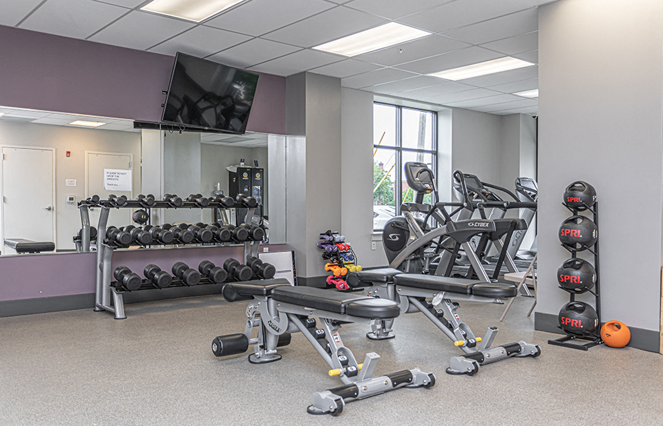 Free weights and cardio machines in apartment fitness center