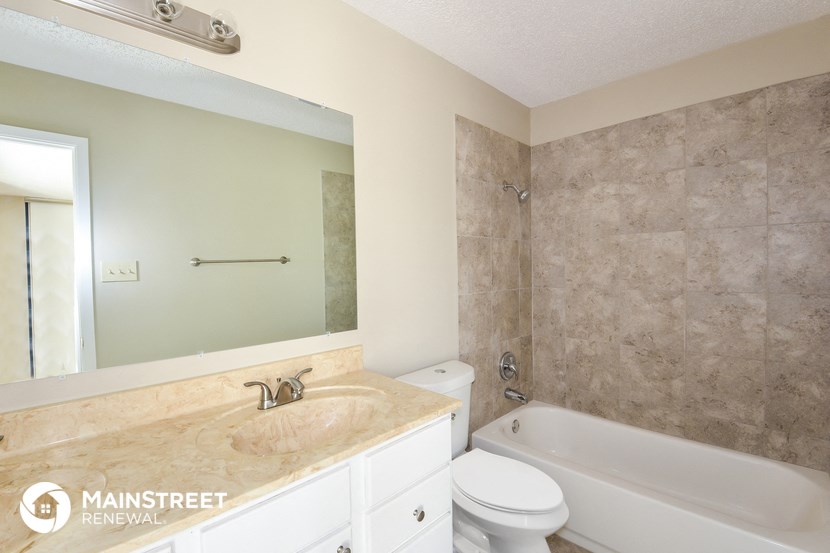 a bathroom with a sink and a tub and a toilet