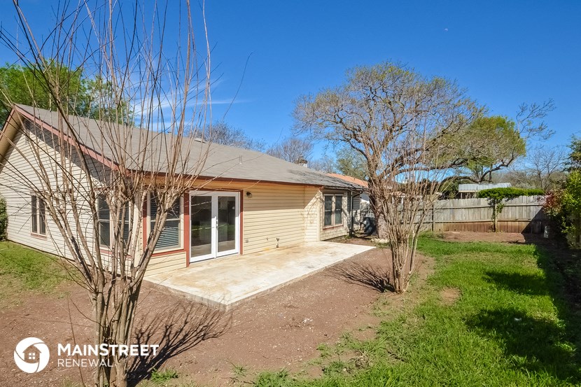 a small house with a porch and a yard