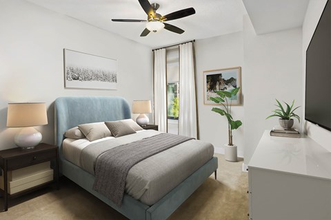 a bedroom with a bed and a ceiling fan