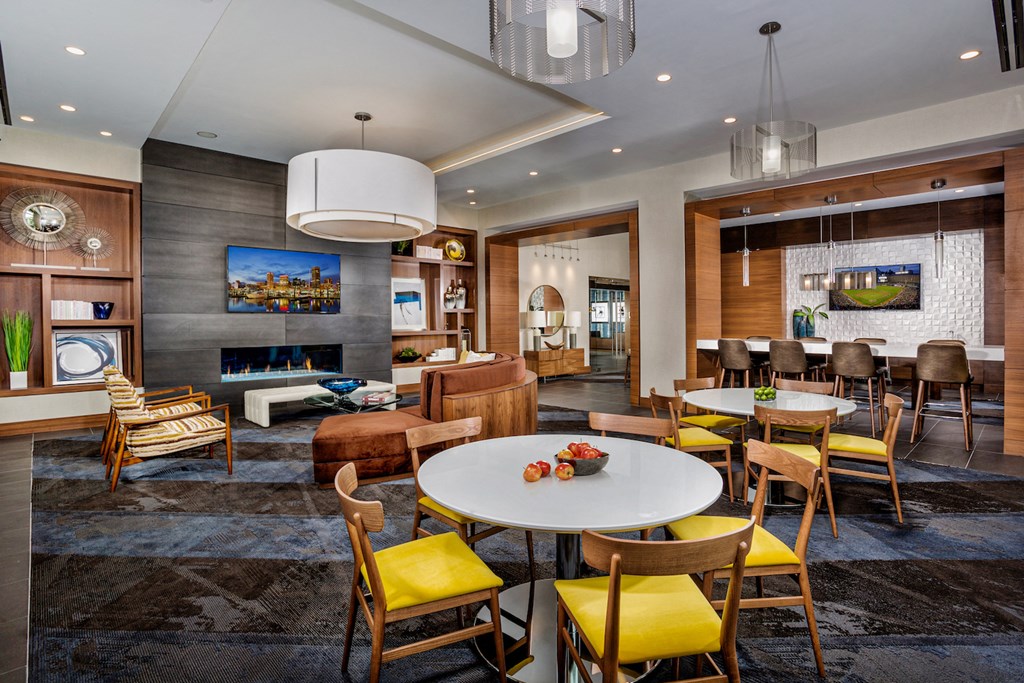 a living room with tables and chairs and a fireplace