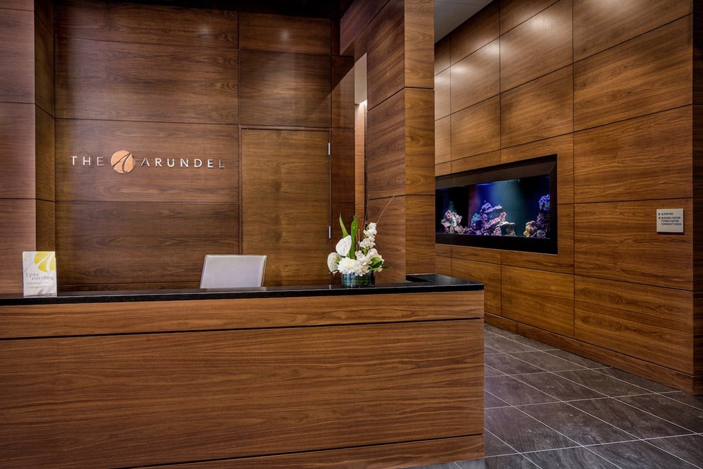 a hotel lobby with a reception desk and a tv