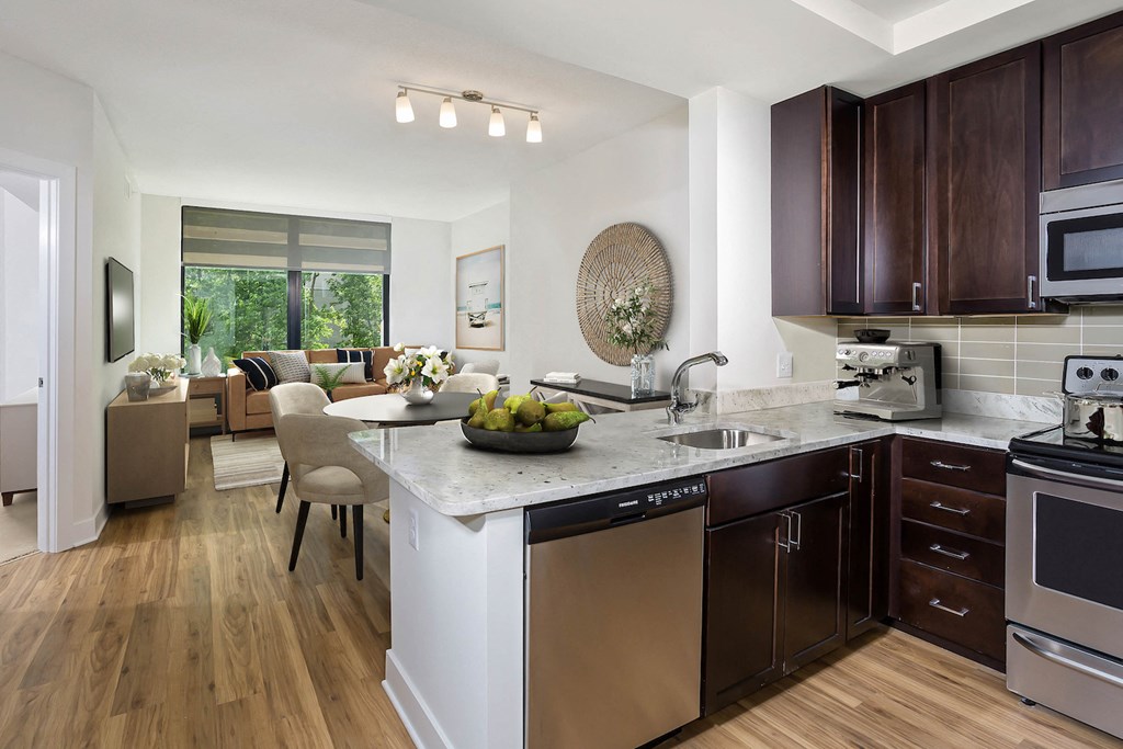 an open kitchen and living room with a large window and