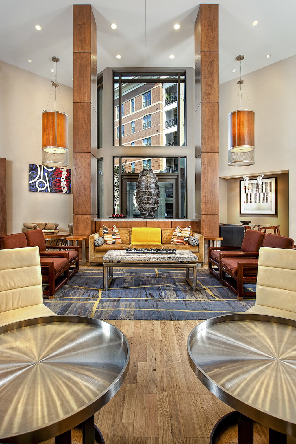 a living room with couches and chairs and a large window