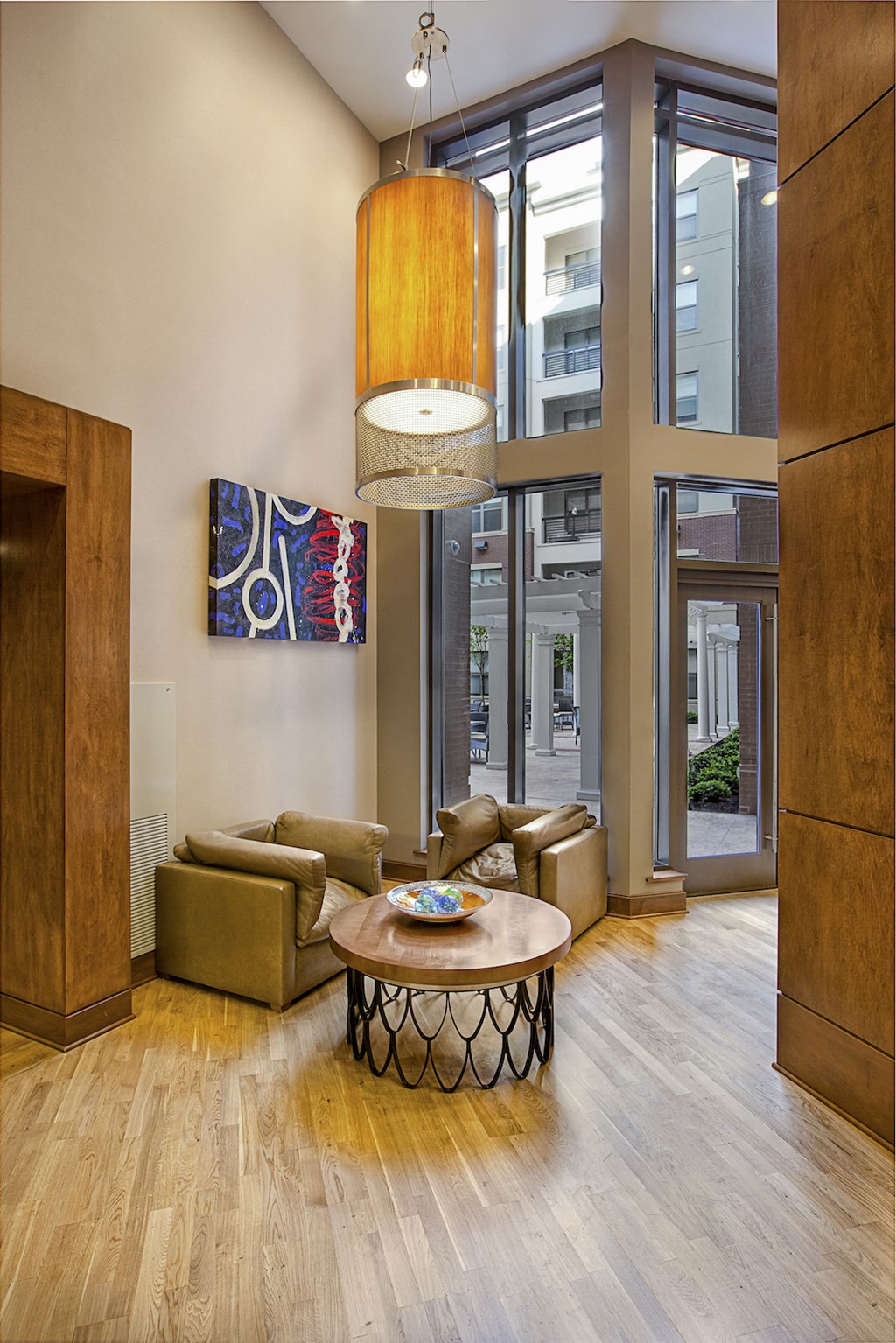 a living room with a table and chairs and a large window