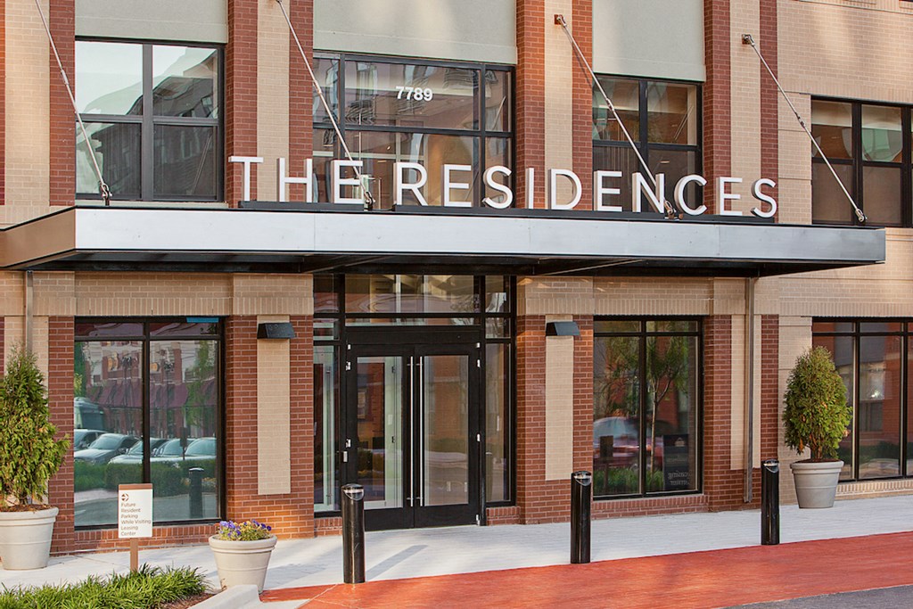 a building with a sign that reads the residences