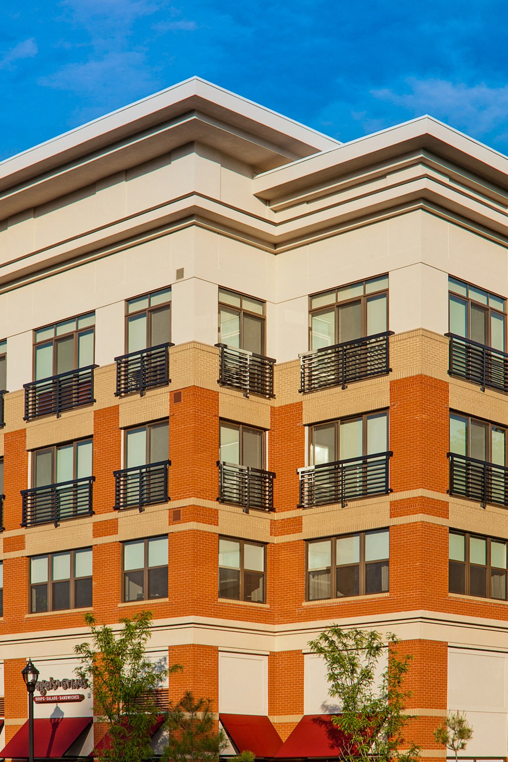 an exterior view of a building with a blue sky in the background