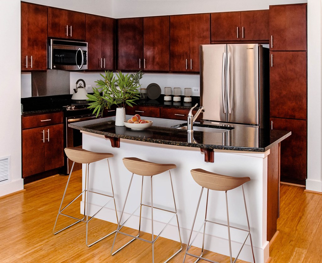 a kitchen with a center island with bar stools
