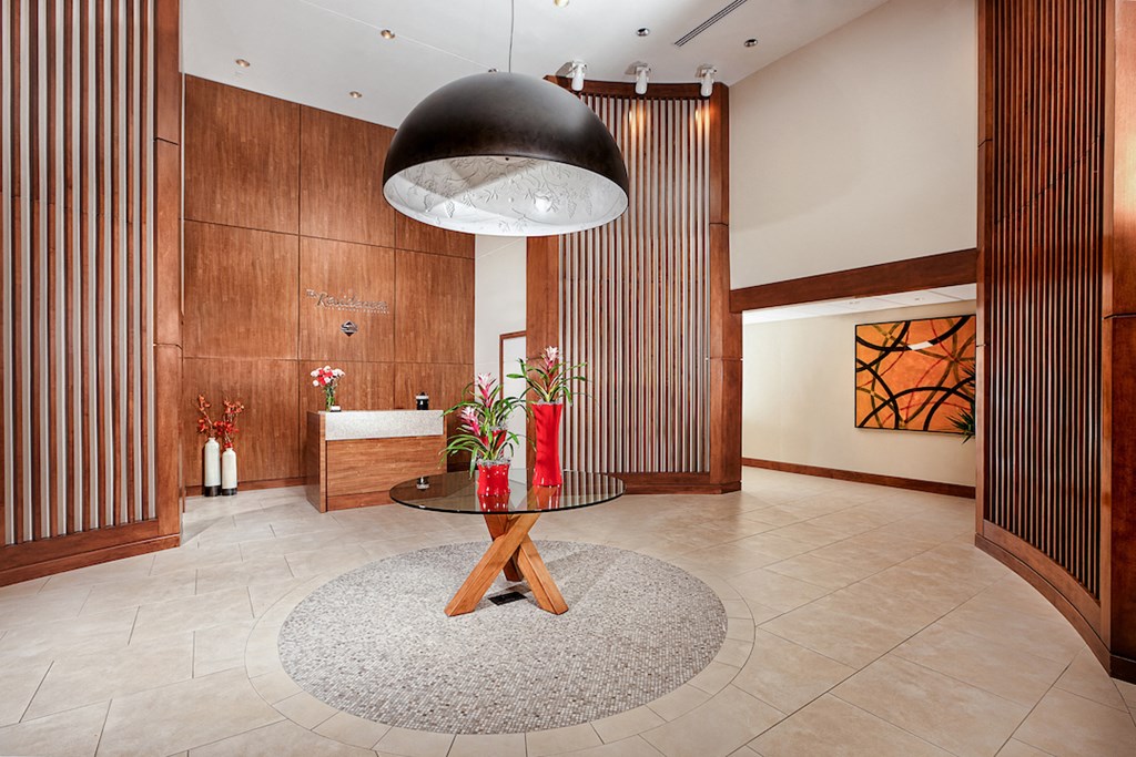 a lobby with a table and a large black light fixture