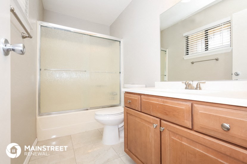 a bathroom with a toilet and a sink and a shower
