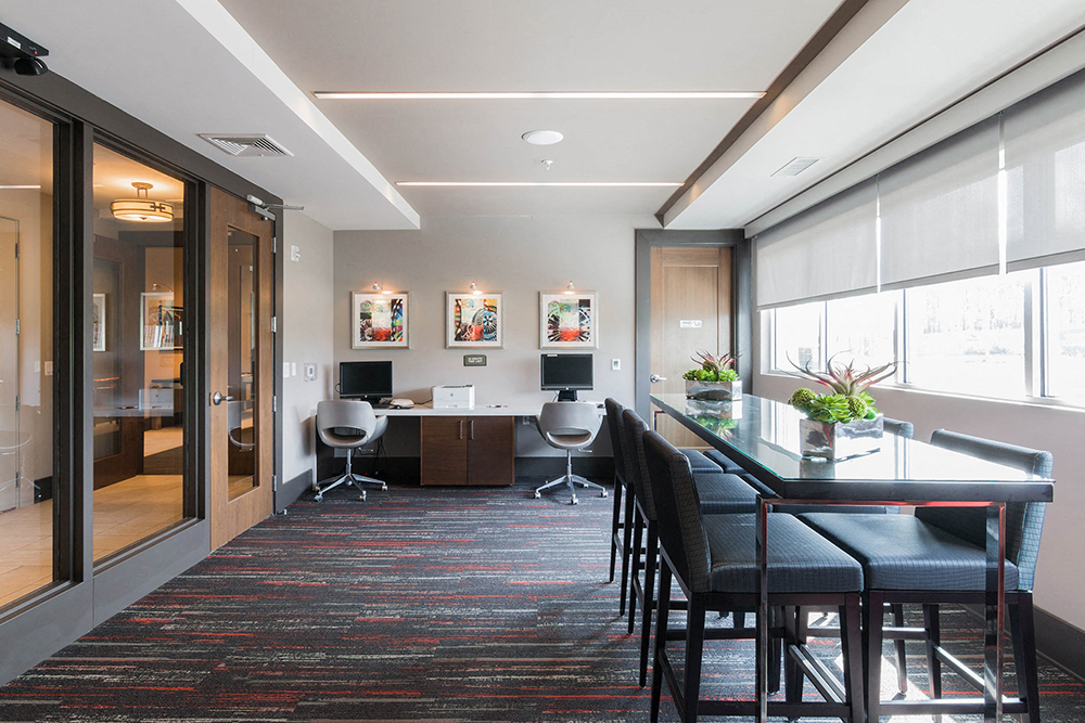 a conference room with a bar and chairs and a desk