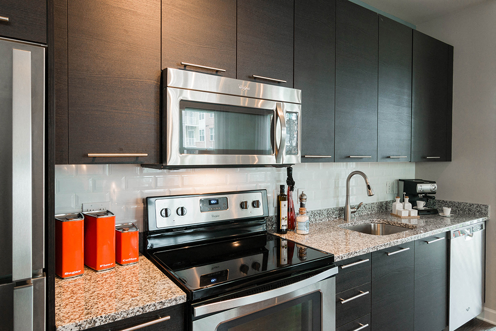 a kitchen with stainless steel appliances and granite counter tops