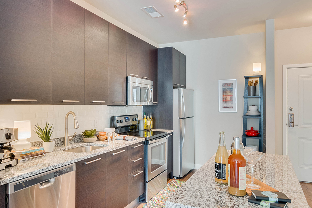 a kitchen with stainless steel appliances and granite counter tops