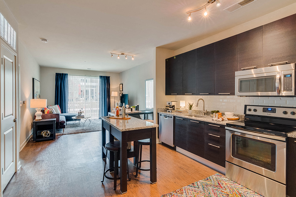 a kitchen with a center island and stainless steel appliances