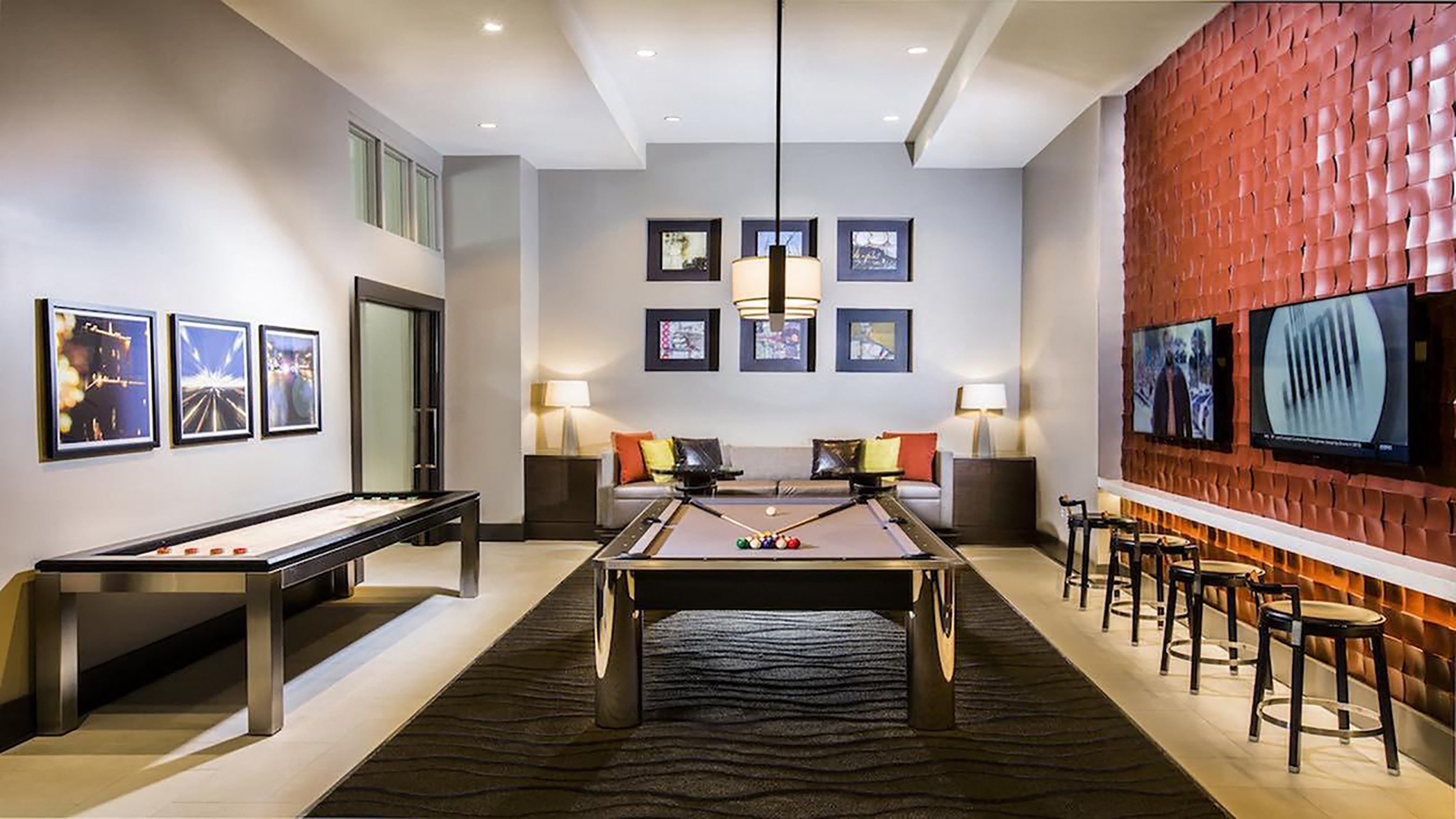 a game room with a pool table and a television