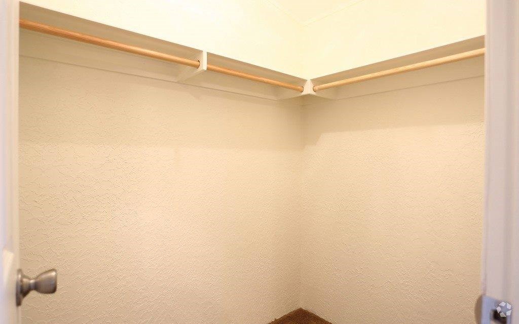 a bathroom with a white wall and a shower curtain