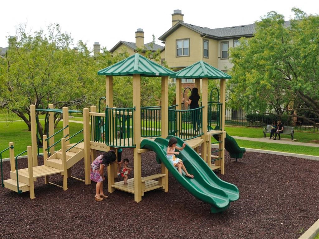 children playing on a playground at a park