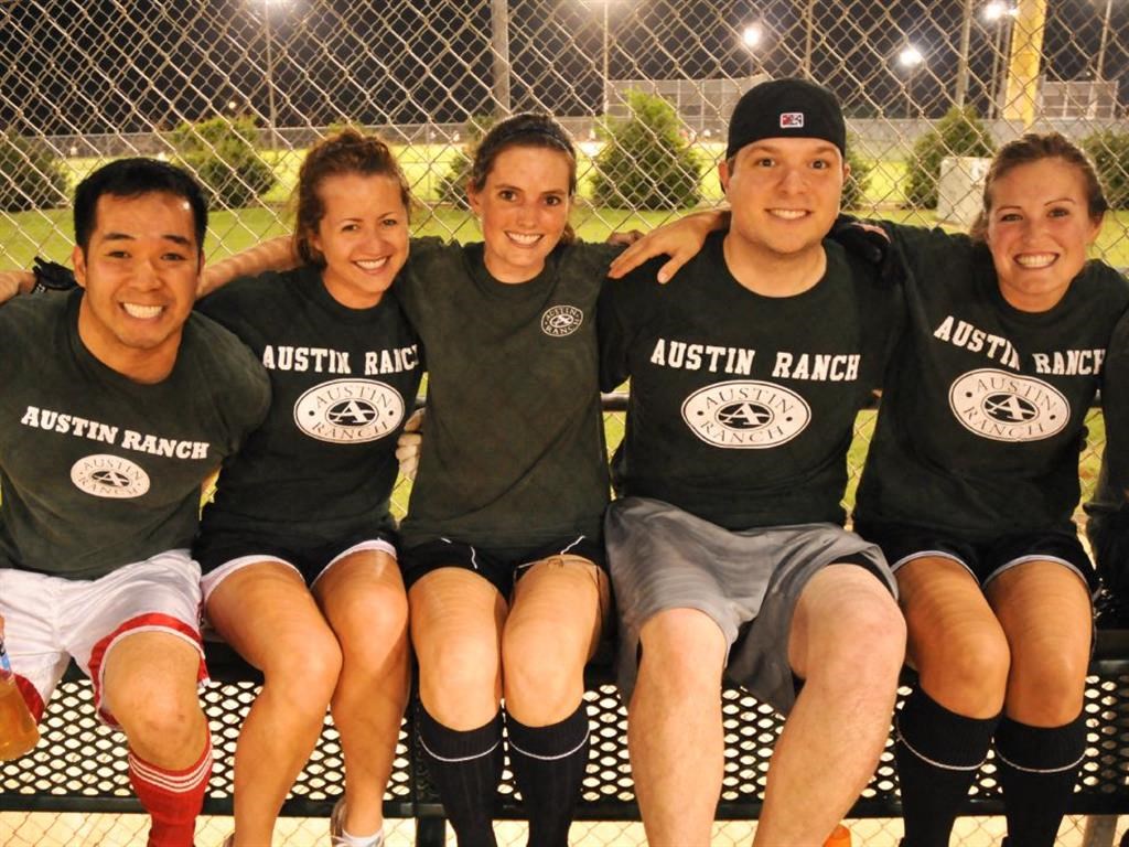 a team of people sitting on a bench