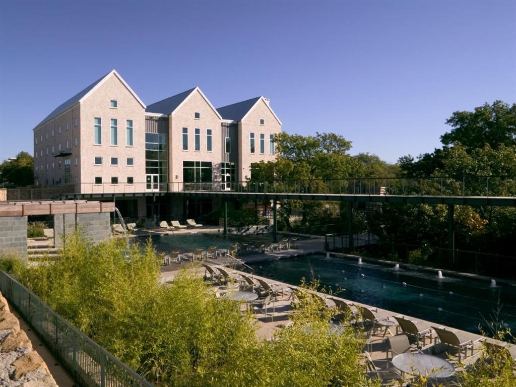 a view of a building with a pond in front of it