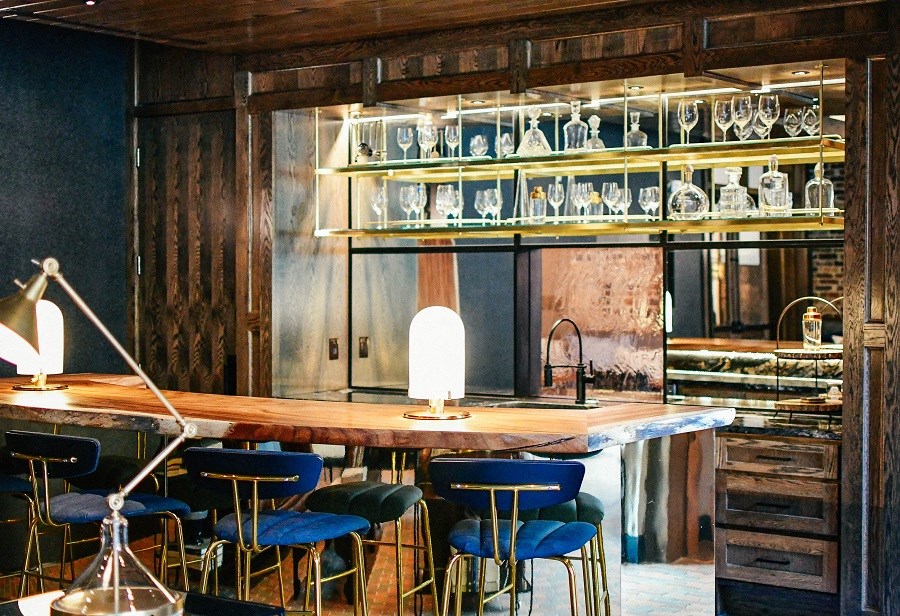 a bar with blue chairs and a wooden table