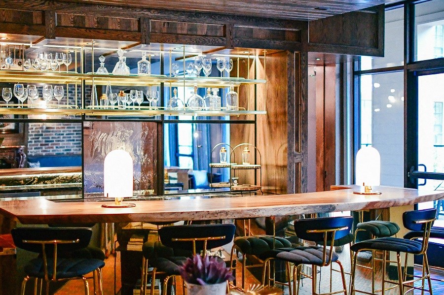 a bar with chairs and a table in a restaurant