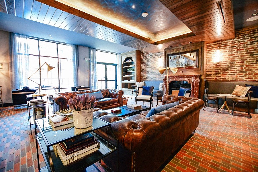 a living room with leather couches and a fireplace