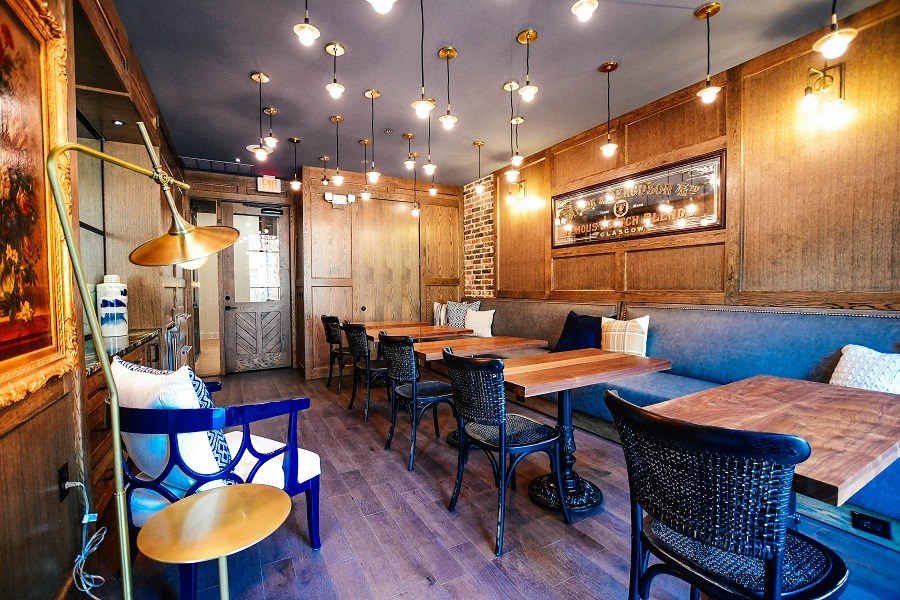 the interior of a restaurant with wooden walls and tables