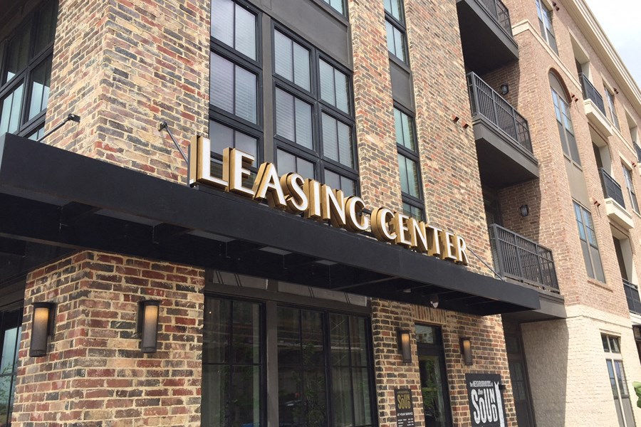 the leasing center on the side of a brick building