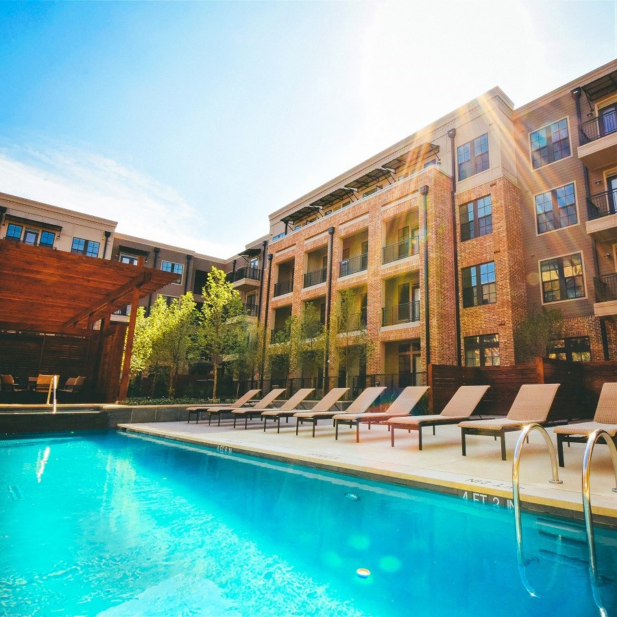 a swimming pool in front of an apartment building