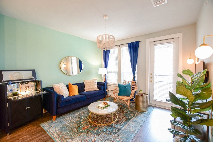 a living room with a blue couch and a coffee table