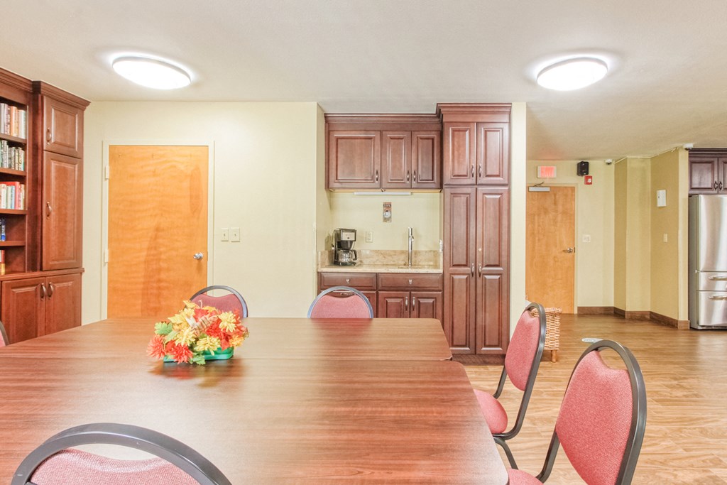 reading room table with coffee station near community kitchen
