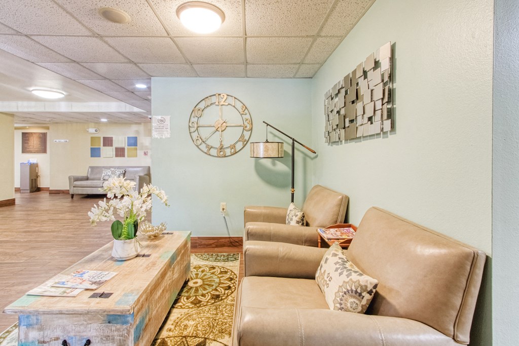 couch, chair, and coffee table in sitting area by elevator