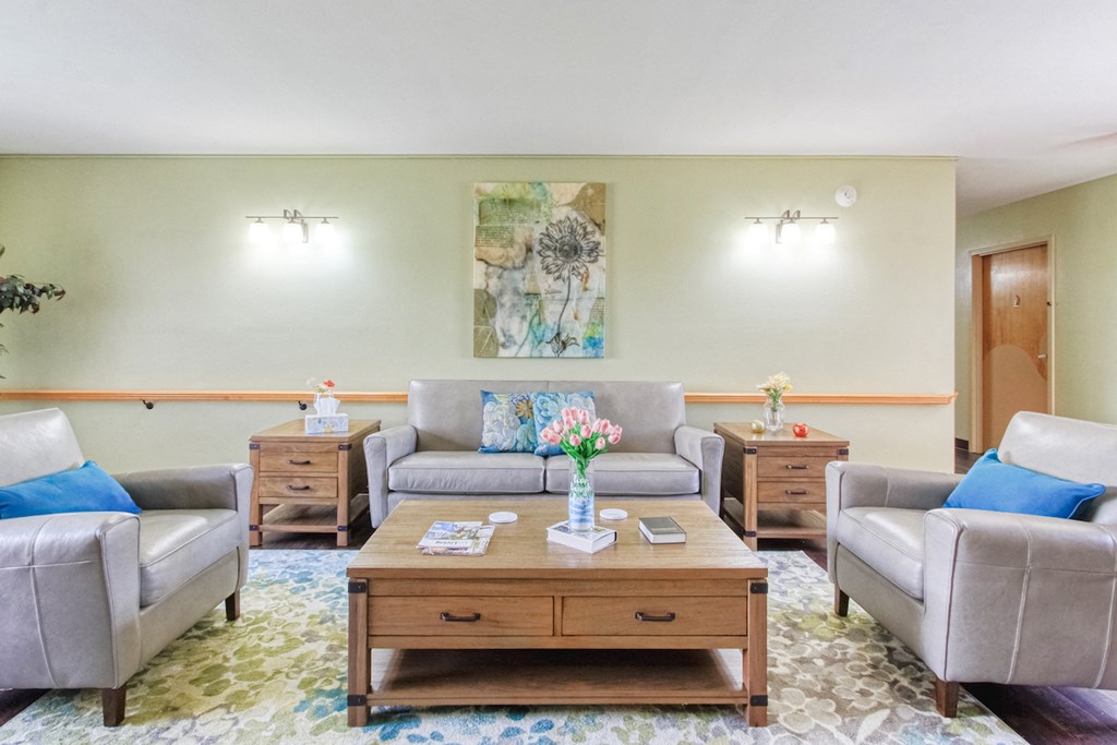 comfortable sitting area with couches, chairs, side and coffee tables