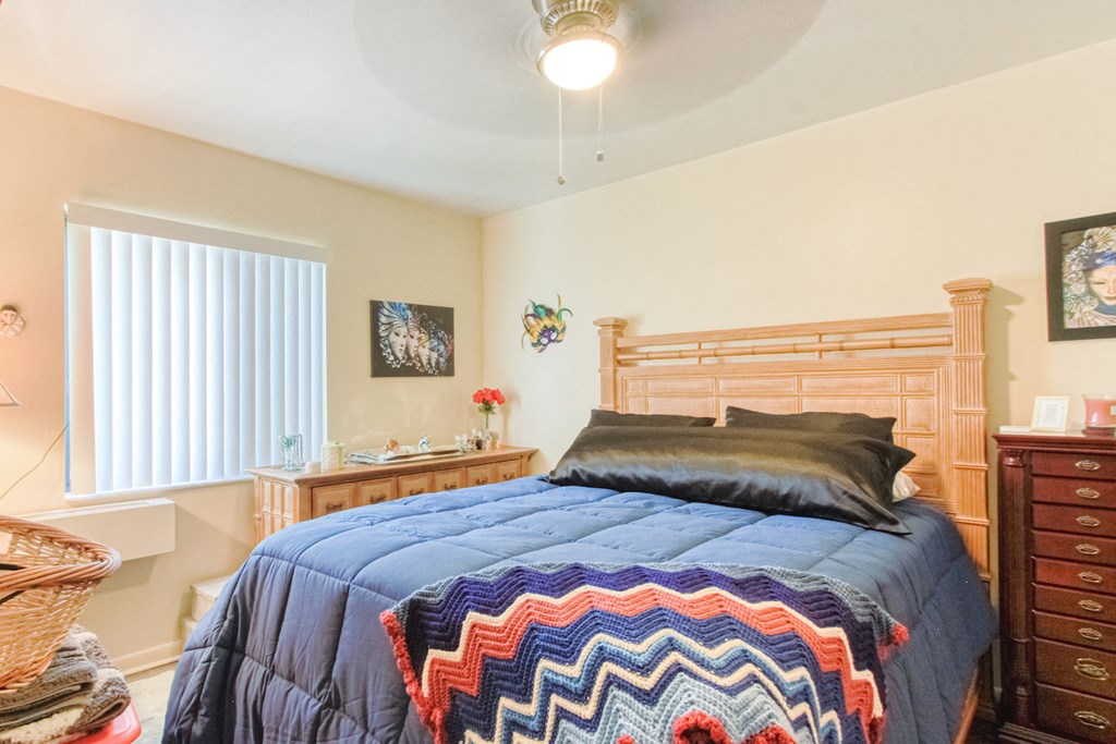VSC-Bedroom1 bedroom with ceiling fan, large window, and model furniture