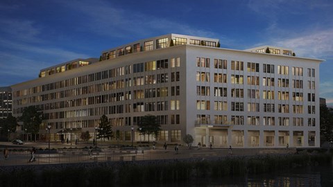 A large white building with many windows is shown in the image.