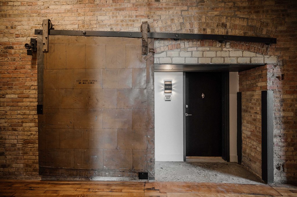 the entrance to a brick building with a black door