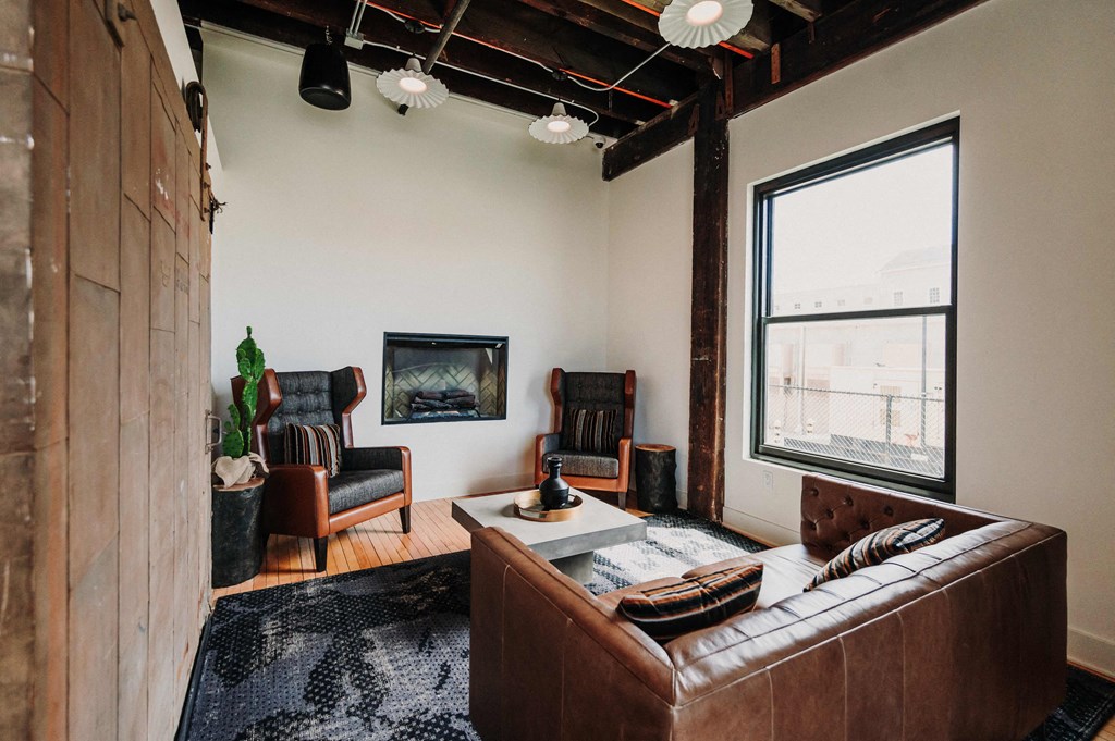 a living room with a couch and chairs and a fireplace