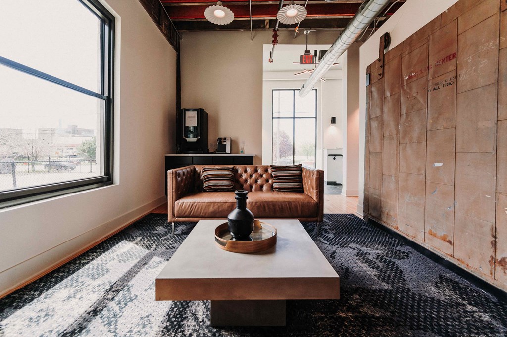 a living room with a leather couch and a coffee table